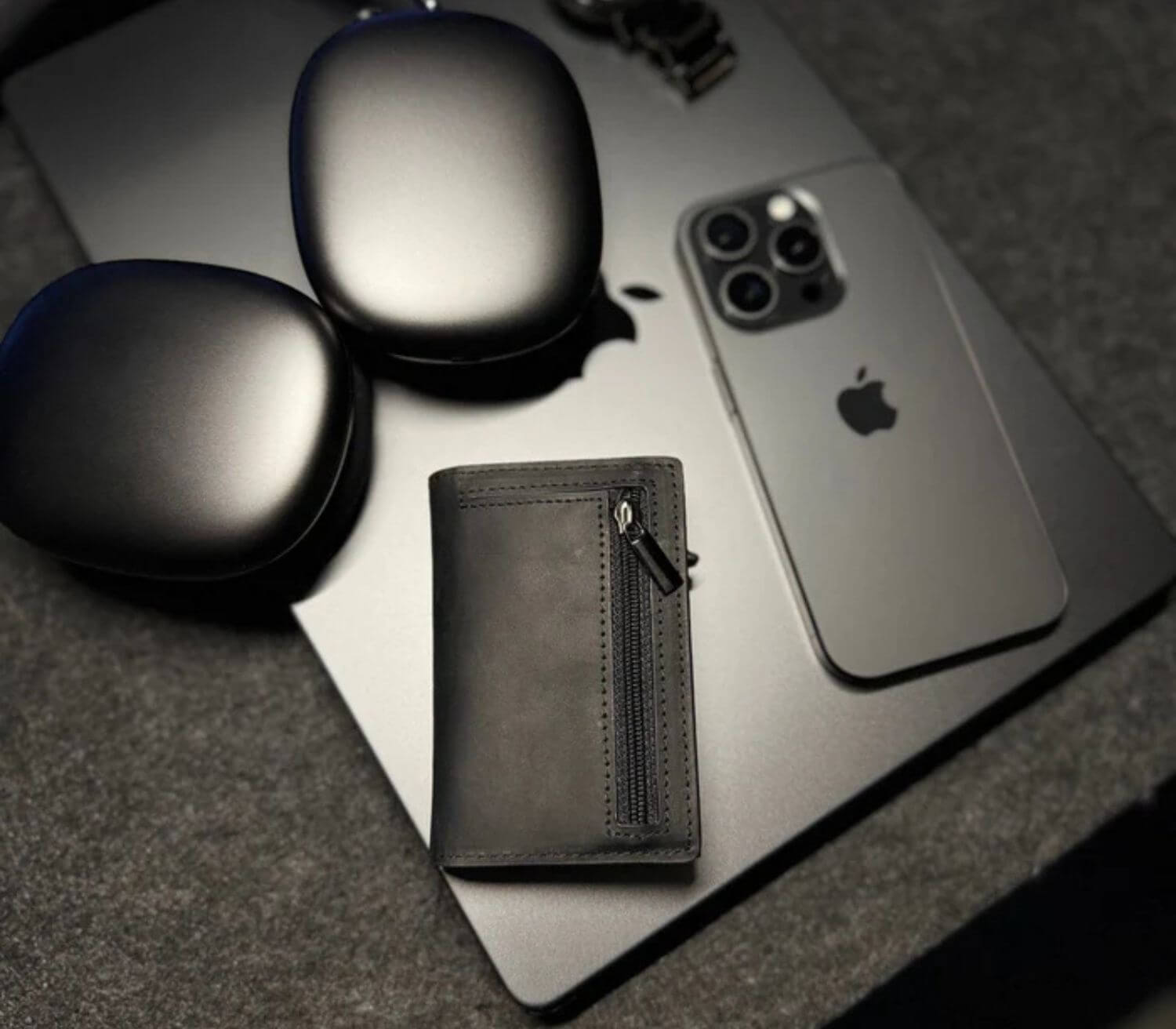 Brown men’s slim leather wallet with zipper pocket styled with iPhone and accessories for a modern look.