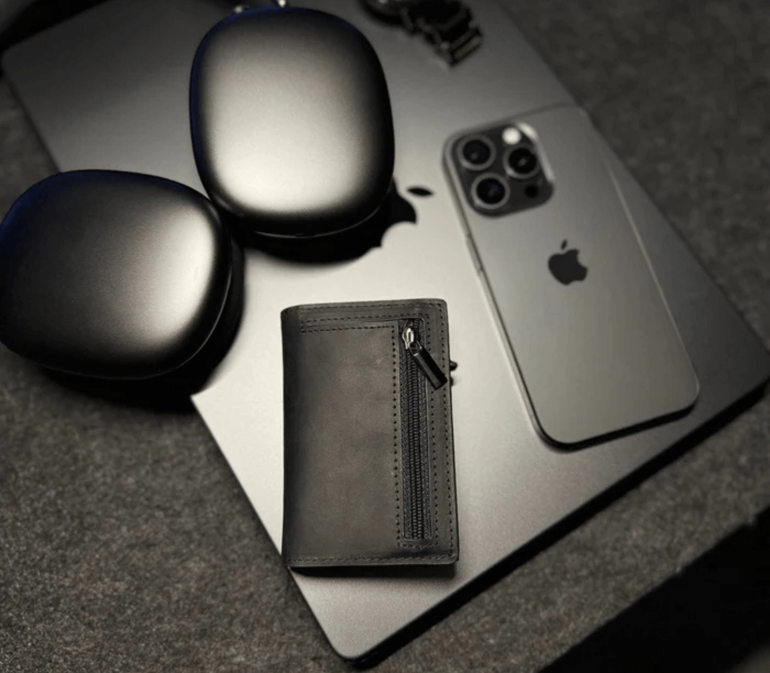 Brown men’s slim leather wallet with zipper pocket styled with iPhone and accessories for a modern look.